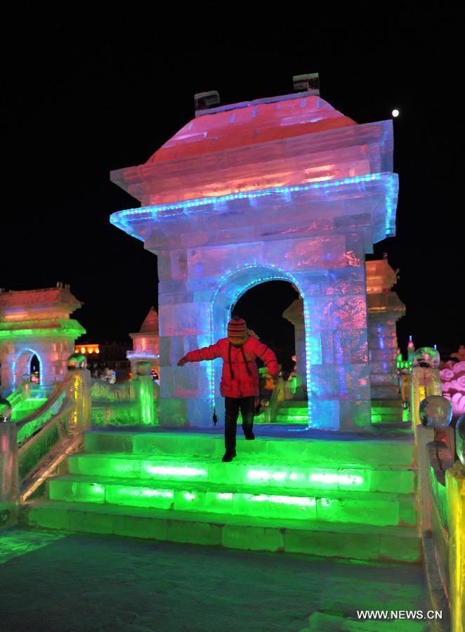 People view ice sculptures in border city Manzhouli in north China's Inner Mongolia Autonomous Region, Dec. 25, 2012. The 14th China, Russia and Mongolia Ice and Snow Sculpture Festival kicked off here on Tuesday. (Xinhua/Asigang)