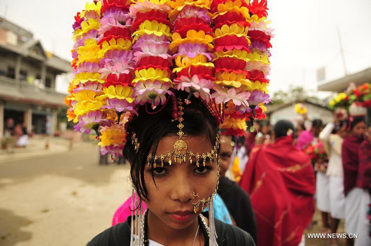 Tharu women participate in the opening ceremony of the 9th International Elephant Festival in Sauraha of Chitwan district, Nepal, Dec. 26, 2012. The festival was organized to promote the tourism and to make awareness of elephant conservation in Nepal. (Xinhua/Sunil Pradhan)