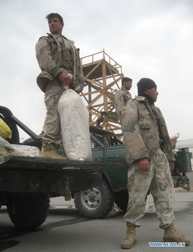 Afghan policemen unload bags of seized hashish during a presentation by Afghan border police in east Afghanistan's Nangarhar Province, Dec. 27, 2012. Afghan border police captured around 800 kilograms of hashish during an operation in Nangarhar province. (Xinhua/Tahir Safi) 