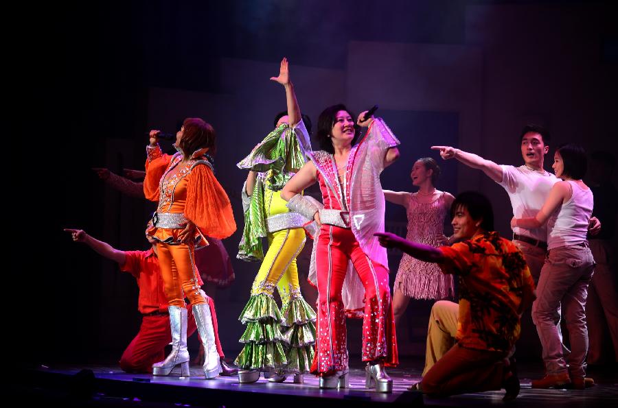 Actors and actresses perform in musical "Mamma Mia!" at the Gansu Grand Theater in Lanzhou, capital of northwest China's Gansu Province, Dec. 26, 2012. The Chinese version of classic musical "Mamma Mia!" was staged in Gansu with six performances starting from Dec. 25. Over 42 million people across the world have seen the musical since the original London production opened in 1999. (Xinhua/Zhang Meng) 