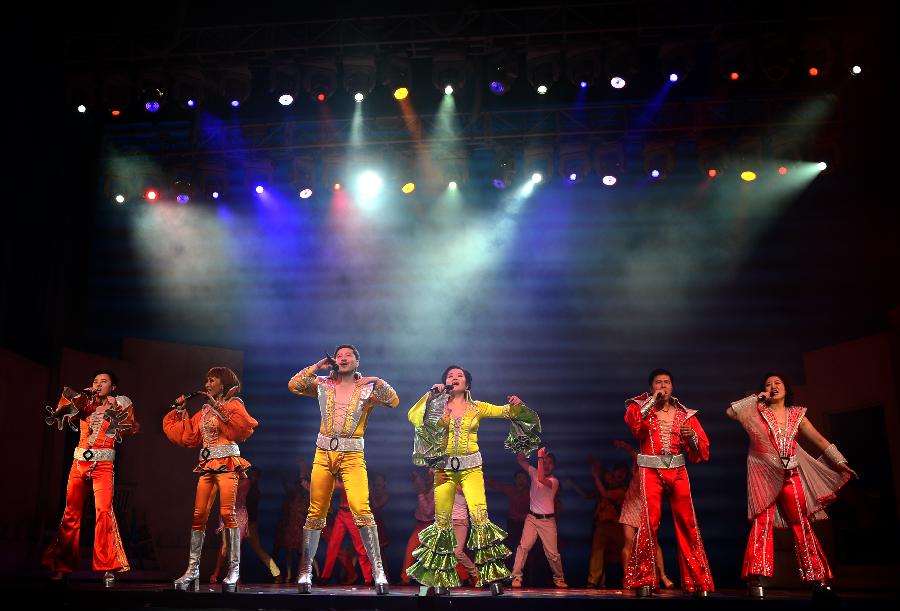 Actors and actresses perform in musical "Mamma Mia!" at the Gansu Grand Theater in Lanzhou, capital of northwest China's Gansu Province, Dec. 26, 2012. The Chinese version of classic musical "Mamma Mia!" was staged in Gansu with six performances starting from Dec. 25. Over 42 million people across the world have seen the musical since the original London production opened in 1999. (Xinhua/Zhang Meng) 