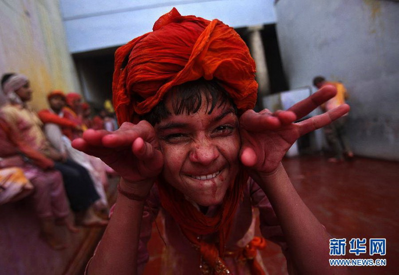 A boy daubed in powder makes fanny face during the celebration of "Lathmar Holi" in India on March 3, 2012. Holi is the most traditional festivial that celebrates the coming of spring, and is marked by joyous participants throwing colored water and powder. (Xinhua/Reuters Photo)