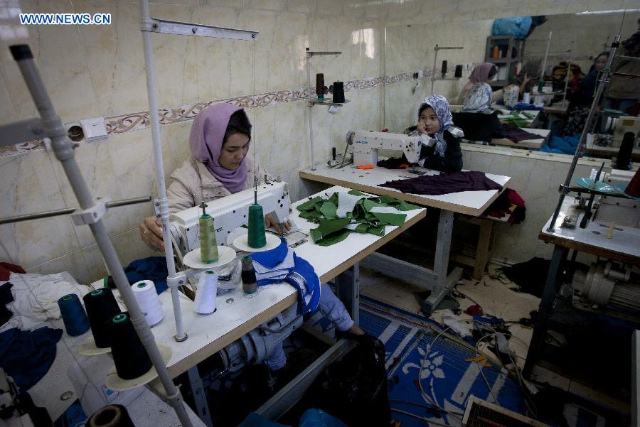 An Afghan refugee sews clothes at a small workshop at a village near Tehran, capital of Iran, on Dec. 28, 2012. The United Nations High Commissioner for Refugees (UNHCR) statistics show that some 2.7 million Afghan refugees are still living outside their homeland due to more than three decades of conflicts and continuing insurgency in Afghanistan, with around 1.7 million in Pakistan and more than one million in Iran, waiting for a favorable environment to return home and reintegrate to their communities. (Xinhua/Ahmad Halabisaz) 