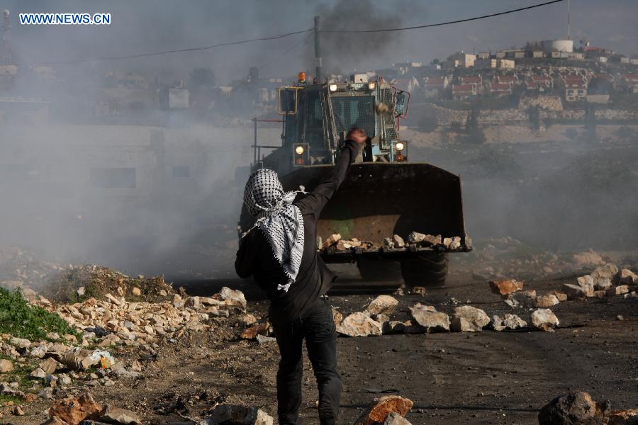 A Palestinian protester is seen during a protest against the expanding of Jewish settlement in Kufr Qadoom village near the West Bank city of Nablus, on Dec. 28, 2012. (Xinhua/Nidal Eshtayeh) 