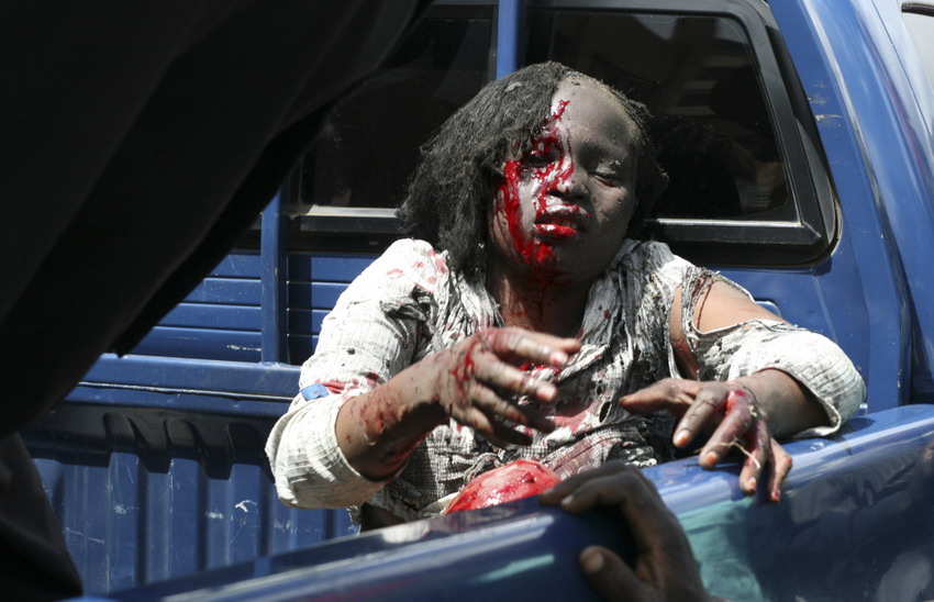 An injured woman sits on a police truck in Nairobi, capital of Kenya on Mar 28, 2012. (Reuters/Johnson Mugo)
