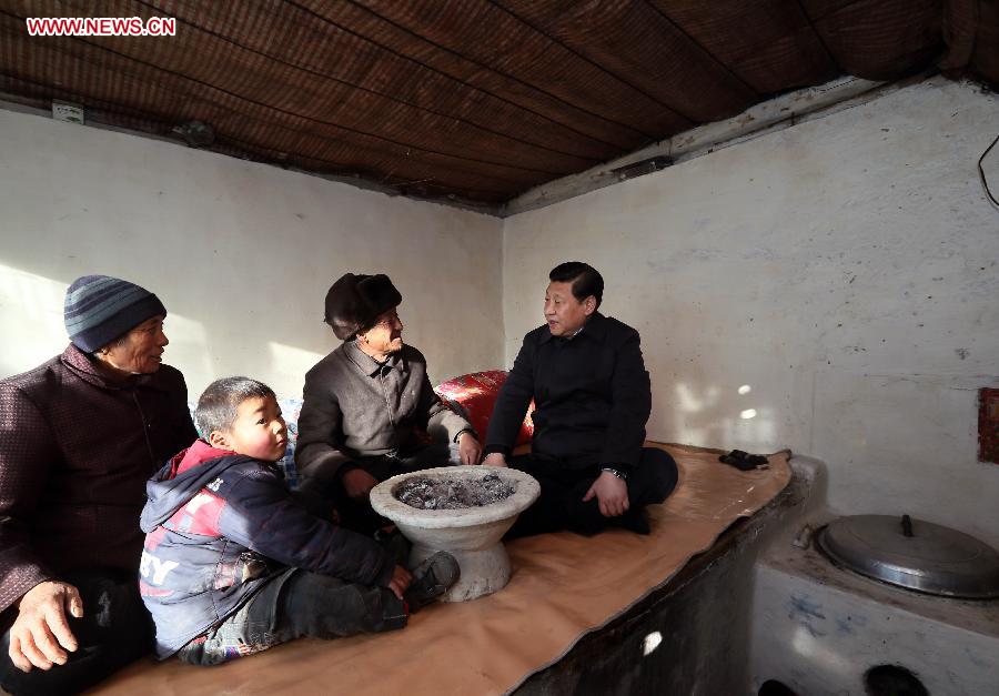 Xi Jinping (R), general secretary of the Communist Party of China (CPC) Central Committee and chairman of the CPC Central Military Commission, visits the family of Tang Rongbin, an impoverished villager in the Luotuowan Village of Longquanguan Township, Fuping County, north China's Hebei Province. Xi made a tour to impoverished villages in Fuping County from Dec. 29 to 30, 2012. (Xinhua/Lan Hongguang)