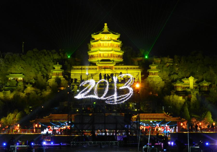 The lights showing number "2013" are staged in front of the Tower of Buddhist Incense at the Summer Palace in Beijing, capital of China, Dec. 31, 2012. Thousands of tourists from home and abroad witnessed the New Year countdown here on Monday night to welcome the new year. (Xinhua/Wang Zhen) 