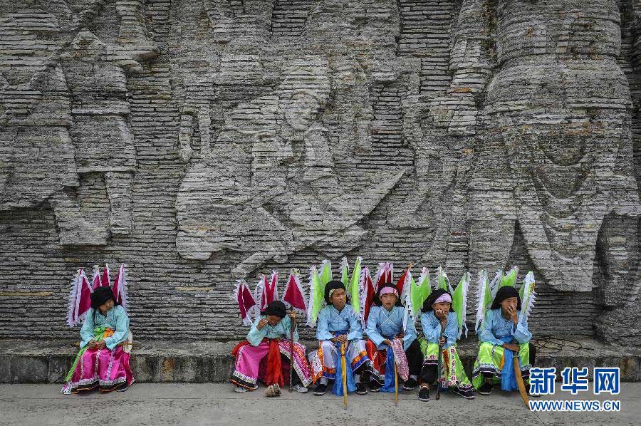Growth is achieved by respect to tradition: Children take a break as they learn Di Opera, a form of folk opera in Anshun, southwest China’s Guizhou province, Aug. 22, 2012. Like the fate of many folk arts in today’s China, 600-year-old Di Opera faces life-or-death challenge because of young people’s declining interest. Fortunately, a village in Anshun launched a project five years ago to train young inheritors of Di Opera during the summer vocation. (Xinhua/Ou Dongqu)
