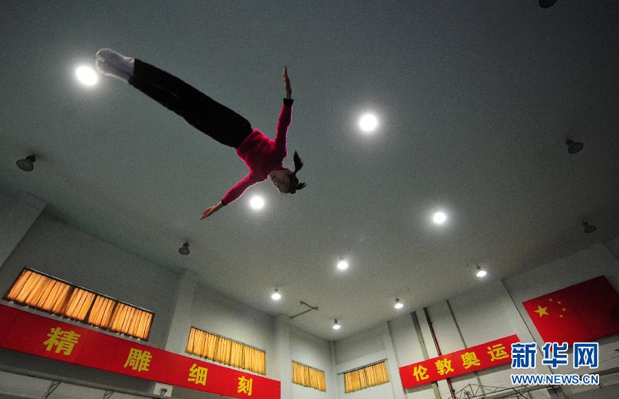 Growth is achieved by sweat: A girl jumps above the trampoline in a sports school in southeast Chinese city Fuzhou, Feb. 27, 2012. (Xinhua/Wei Peiquan)