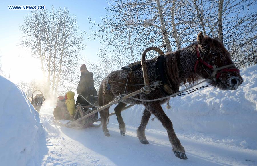 A herdsman of Kazak ethnic group controls a sledge dragged by a horse after snowfall in Altay, northwest China's Xinjiang Uygur Autonomous Region, Dec. 28, 2012. Beautiful snow scenery here attracts a good many tourists. (Xinhua/Sadat)