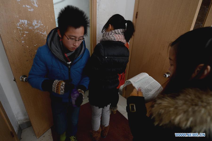 A student prepares for the upcoming National Entrance Examination for Postgraduate (NEEP) while waiting to fetch water in Anhui University in Hefei, capital of east China's Anhui Province, Jan. 3, 2013. Examinees taking the NEEP scheduled on Jan. 5 have rocketed up to 1.8 million this year, hitting an all-time high. (Xinhua/Zhang Rui)