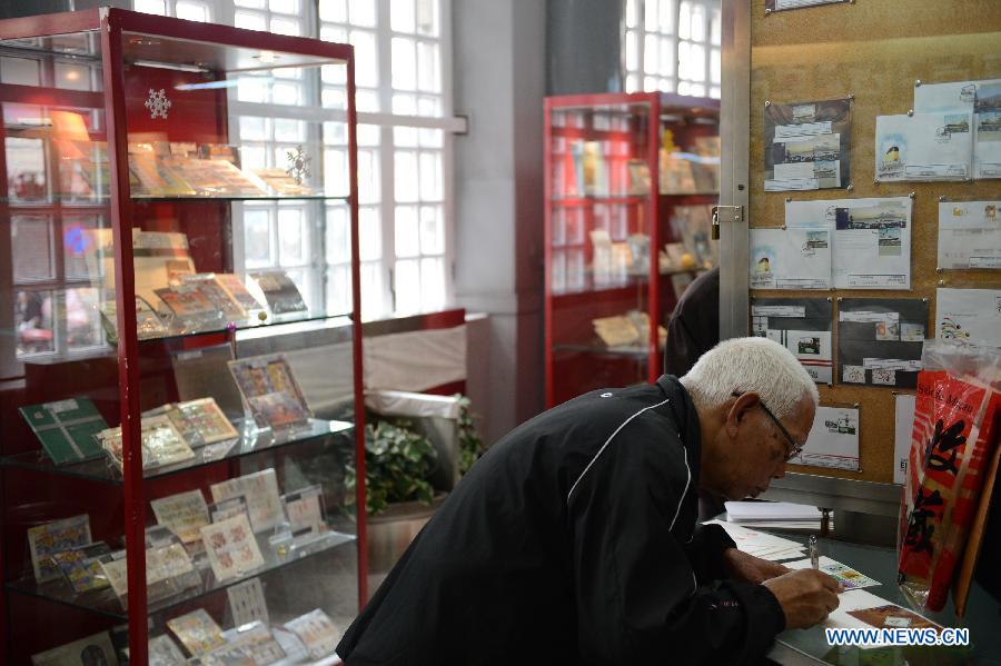 A citizen writes on a letter at a post office in Macao, south China, Jan. 3, 2013. (Xinhua/Cheong Kam Ka)