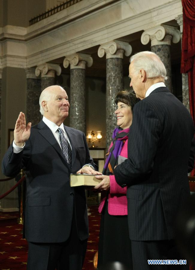Sen. Ben Cardin (D-MD) raises his right hands while Vice President Joe Biden delivers the ceremonial swearing-in remarks in the Old Senate Chamber on Capitol Hill on Thursday, January 3, 2013. The new U.S. Congress convened on Thursday with new members being sworn in. (Xinhua/Fang Zhe)