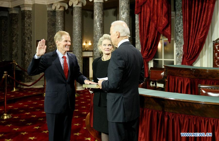 Sen. Bill Nelson (D-FL)(L) raises his right hands while Vice President Joe Biden delivers the ceremonial swearing-in remarks in the Old Senate Chamber on Capitol Hill on Thursday, January 3, 2013. The new U.S. Congress convened on Thursday with new members being sworn in. (Xinhua/Fang Zhe) 