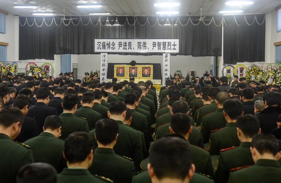 People gather to mourn for the deceased firefighters who lost lives in a rescue operation on Jan. 1 at the Hangzhou Yusei Machinery Co., Ltd during memorial meeting in Hangzhou, capital of east China's Zhejiang Province, Jan. 4, 2013. (Xinhua/Han Chuanhao) 