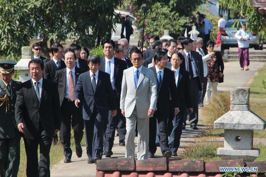 Japanese Deputy Prime Minister and Finance Minister Taro Aso (in White, Front) visits the War Cemetery in Yangon, Myanmar, Jan. 4, 2013. Japanese Deputy Prime Minister and Finance Minister Taro Aso's visit to the War Cemetery in Yangon's suburban area Friday has raised protests by some war veterans who experienced the Japanese aggressive war in Myanmar. (Xinhua/U Aung) 