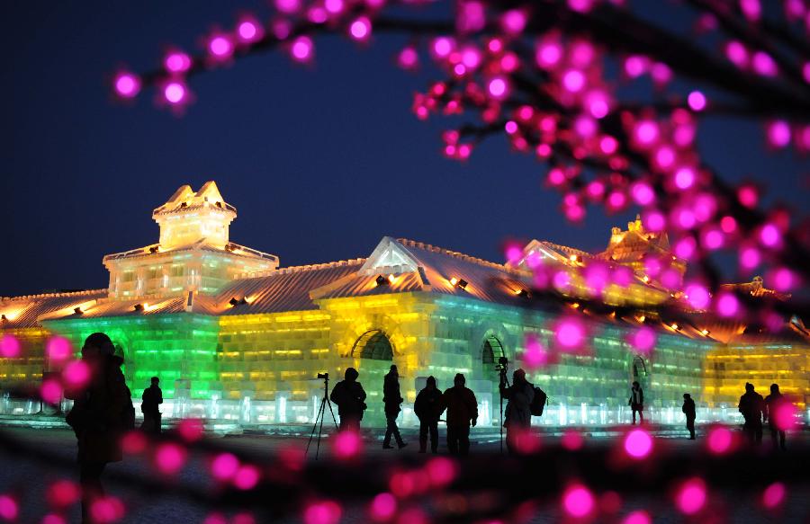 Visitors take photo of the night scenery of the Ice and Snow World during the 29th Harbin International Ice and Snow Festival in Harbin, capital of northeast China's Heilongjiang Province, Jan. 5, 2013. The festival kicked off on Saturday. (Xinhua/Wang Jianwei)