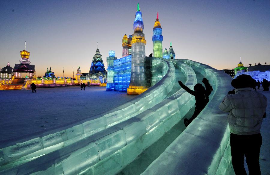 A visitor takes an ice slide in the Ice and Snow World during the 29th Harbin International Ice and Snow Festival in Harbin, capital of northeast China's Heilongjiang Province, Jan. 5, 2013. The festival kicked off on Saturday. (Xinhua/Wang Jianwei)