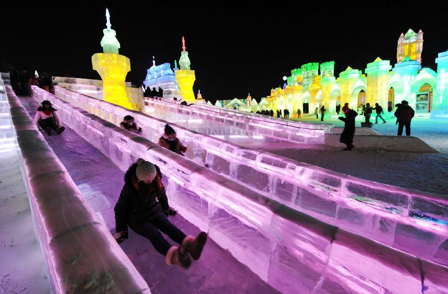 Visitors take ice slides in the Ice and Snow World during the 29th Harbin International Ice and Snow Festival in Harbin, capital of northeast China's Heilongjiang Province, Jan. 5, 2013. The festival kicked off on Saturday. (Xinhua/Wang Jianwei)