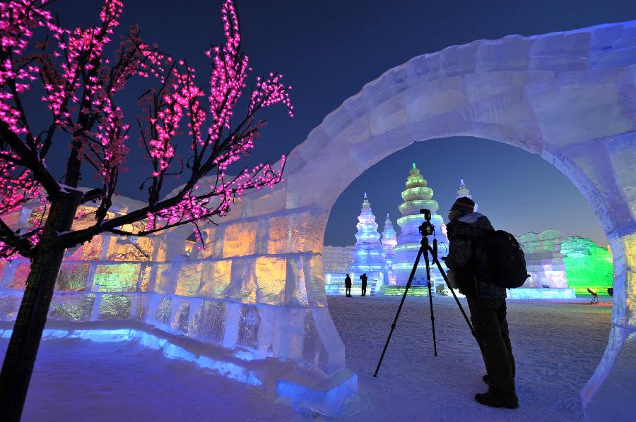 A man takes photo of scenery in the Ice and Snow World during the 29th Harbin International Ice and Snow Festival in Harbin, capital of northeast China's Heilongjiang Province, Jan. 5, 2013. The festival kicked off on Saturday. (Xinhua/Wang Jianwei)