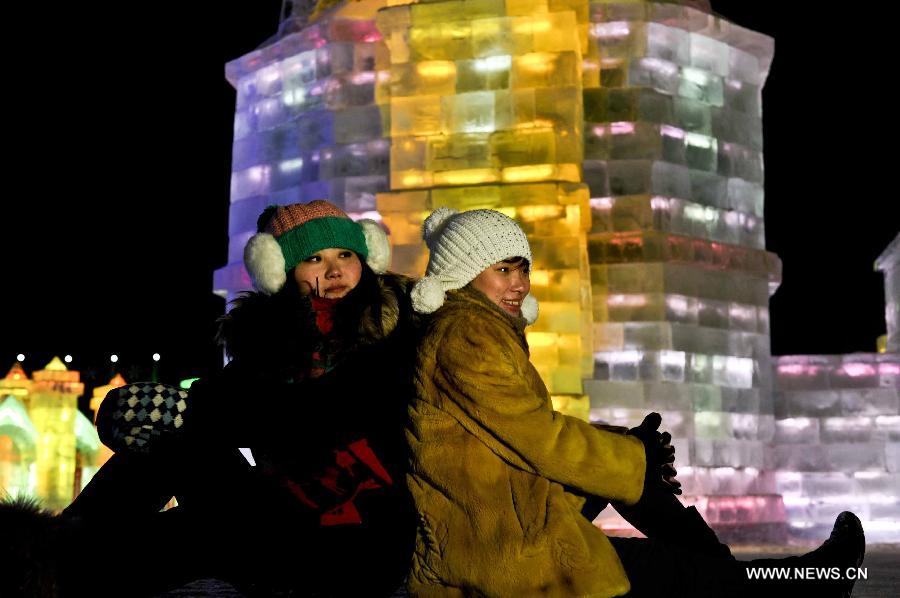 Visitors pose for photos in front of ice sculptures in the Ice and Snow World during the 29th Harbin International Ice and Snow Festival in Harbin, capital of northeast China's Heilongjiang Province, Jan. 5, 2013. The festival kicked off on Saturday. (Xinhua/Wang Song)