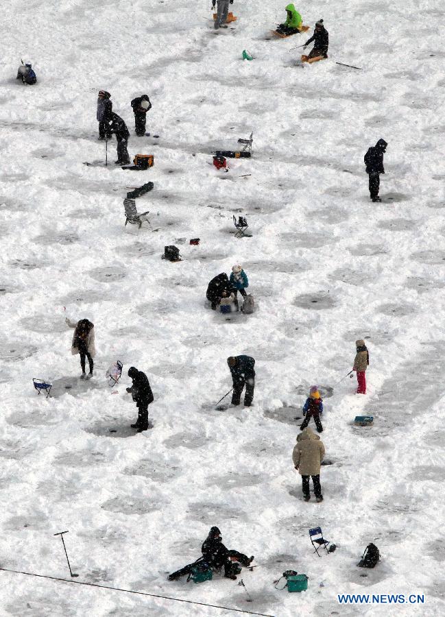 People fish on a frozen river during 2013 Hwacheon Sancheoneo Ice Festival in Hwacheon, South Korea, Jan. 5, 2013. The Sancheoneo Ice Festival lasts from Jan. 5 to 27. (Xinhua/Park Jin hee) 
