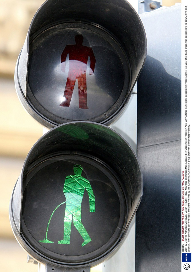 Altered traffic signs with red and green men appearing to lie down, drink and defecate appear in Prague in April 2012. The signs were deemed illegal and were removed by the authorities, Guerrilla art group Ztohoven claimed responsibility.  (Isifa Image Service sro/ Rex Fe/ ImagineChina) 