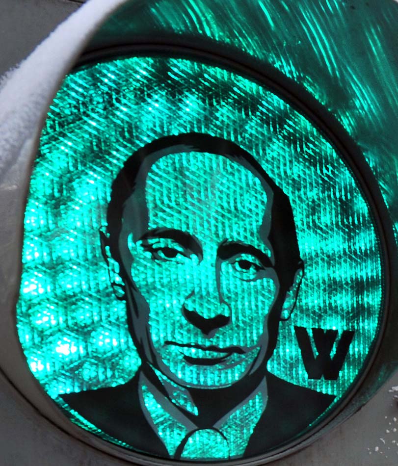 A green traffic light illuminates a transparent image of Russian Prime Minister Vladimir Putin, which was apparently stuck to the device by the Russian strongman’s supporters in central Moscow, Feb, 13, 2012. (ImagineChina/ Yuri Kadobnov)