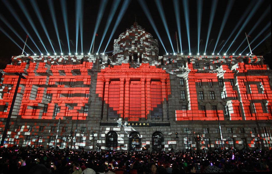The sign of “I love Shanghai” is seen in a 4D light show held to welcome the New Year in the Bund, Shanghai, Dec. 31, 2012. (Xinhua/Ding Ting)
