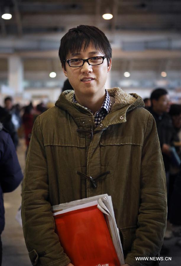 Wu Zhao, a 24-year-old graduate from Beijing Jiaotong University who is majored in Circuits and Systems, is seen at a job fair for postgraduates in Beijing, capital of China, Jan. 6, 2013. Wu has no specific requirement for starting salary. Looking for a promising job is the priority for him. But he would also like to start his own business back in hometown once he got some experience. (Xinhua/Wan Xiang)  