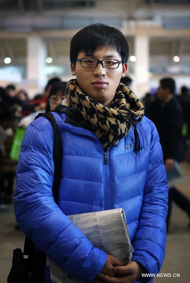 Wan Xin, a 24-year-old graduate from Tianjin Polytechnic University who is majored in Automation, is seen at a job fair for postgraduates in Beijing, capital of China, Jan. 6, 2013. Wan wants to work in the field of hardware development in a state-owned enterprise with a starting salary no less than 6,000 yuan (about 963 U.S. dollars) per month. (Xinhua/Wan Xiang)  