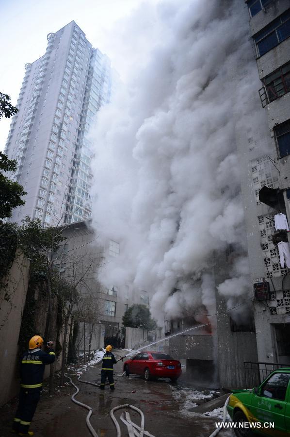 Firefighters extinguish fire at a residential building on the Honggu Road in Nanchang, capital of east China's Jiangxi Province, Jan. 6, 2013. A fire broke out on the first floor of the building on Sunday. No casualty is reported at present and the cause is still under investigation. (Xinhua/Zhou Mi) 
