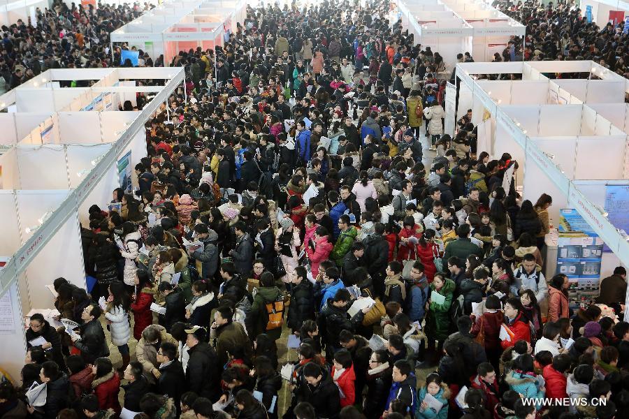 Job seekers cram the venue of a job fair held at China International Exhibition Center in Beijing, China, Jan. 6, 2013. The job fair, held for postgraduates, provided 18,000 job vacancies and was expected to attract 40,000 job seekers. (Xinhua/Wan Xiang) 
