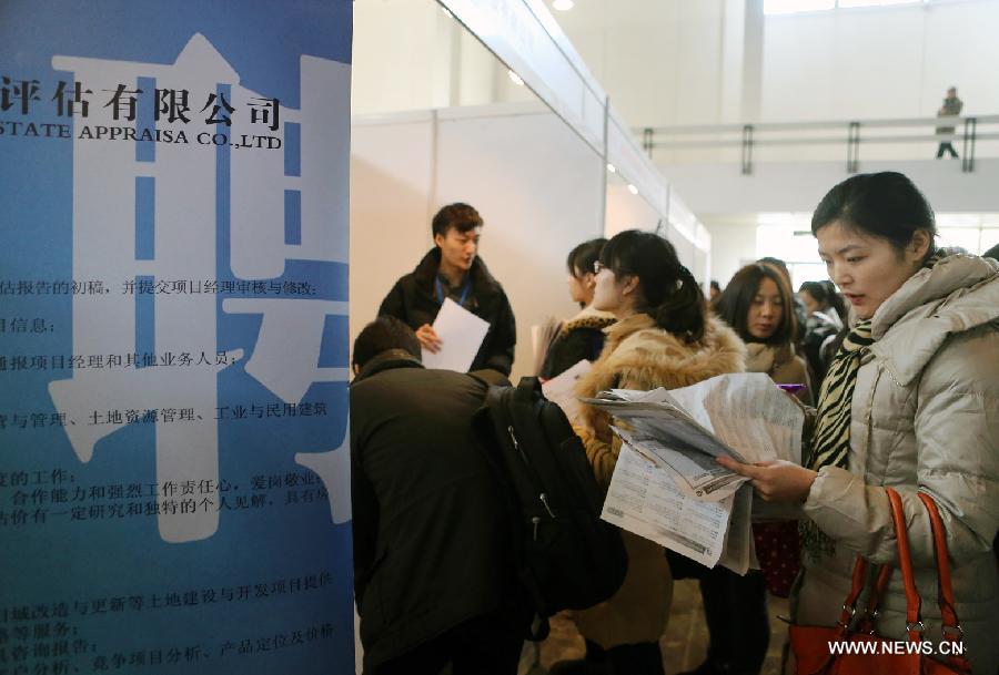 A job seeker searches for job vacancy information at a job fair held at China International Exhibition Center in Beijing, China, Jan. 6, 2013. The job fair, held for postgraduates, provided 18,000 job vacancies and was expected to attract 40,000 job seekers. (Xinhua/Wan Xiang) 