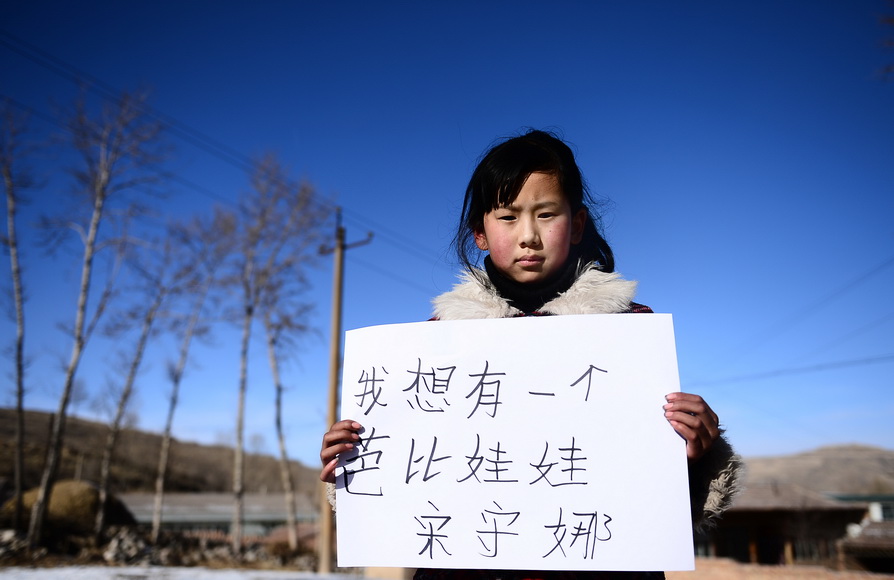 Song Shouna, 10, third-grade pupil of Wanquan primary school in Datong, Qinghai. Her New Year wish: I want to have a Barbie doll. (Xinhua/Zhang Hongxiang)