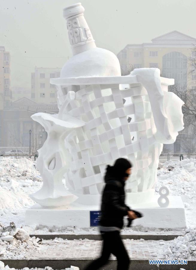 A college student walks past a creation during the 5th International Snow Sculpture Contest for College Students in Harbin, capital of northeast China's Heilongjiang Province, Jan. 7, 2013. The contest, which attracted 58 teams from countries and regions including Britain, Japan, Russia, Thailand and the United States will come to an end soon. (Xinhua/Wang Song)  
