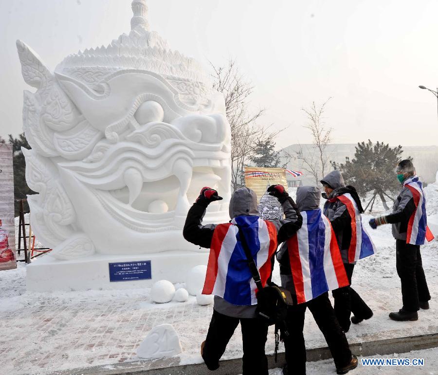 College students from Thailand stand in front of a creation during the 5th International Snow Sculpture Contest for College Students in Harbin, capital of northeast China's Heilongjiang Province, Jan. 7, 2013. The contest, which attracted 58 teams from countries and regions including Britain, Japan, Russia, Thailand and the United States will come to an end soon. (Xinhua/Wang Song) 