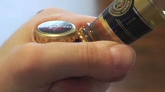 Have no bottle opener? Try to open it with another. (Source: Xinhuanet.com)
