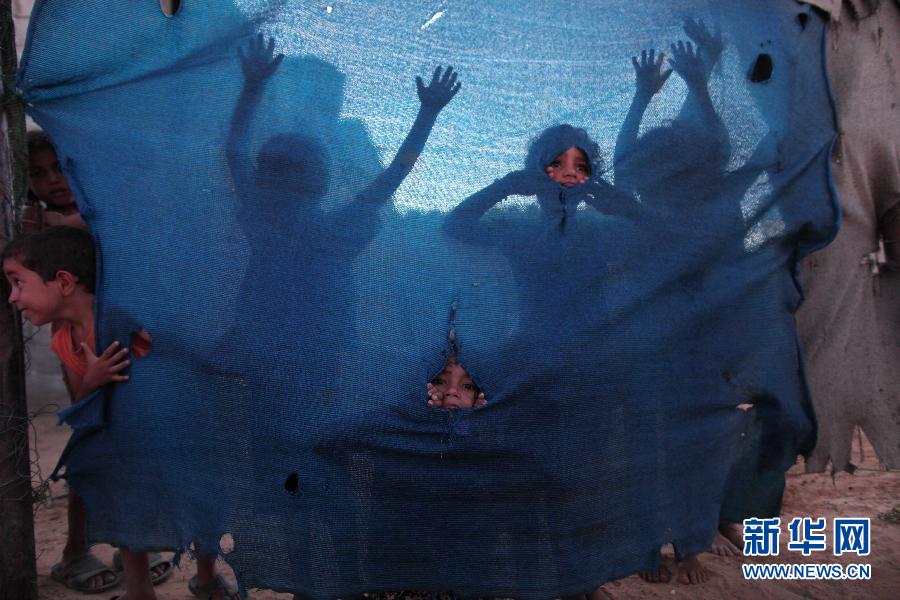 Palestinian refugee children play at a poor suburb in Gaza City before Breaking fast on the Holy month of Ramadan on Aug. 7, 2012. (Xinhua/Wissam Nassar)