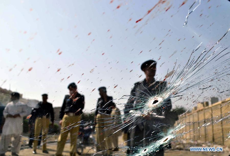 People gather around a damaged vehicle at the shootout site in southwest Pakistan's Quetta, on Aug. 30, 2012. A local judge, his bodyguard and driver were killed by unidentified gunmen in Quetta in the moring of Aug. 30, 2012, local media reported. (Xinhua/Mohammad) 