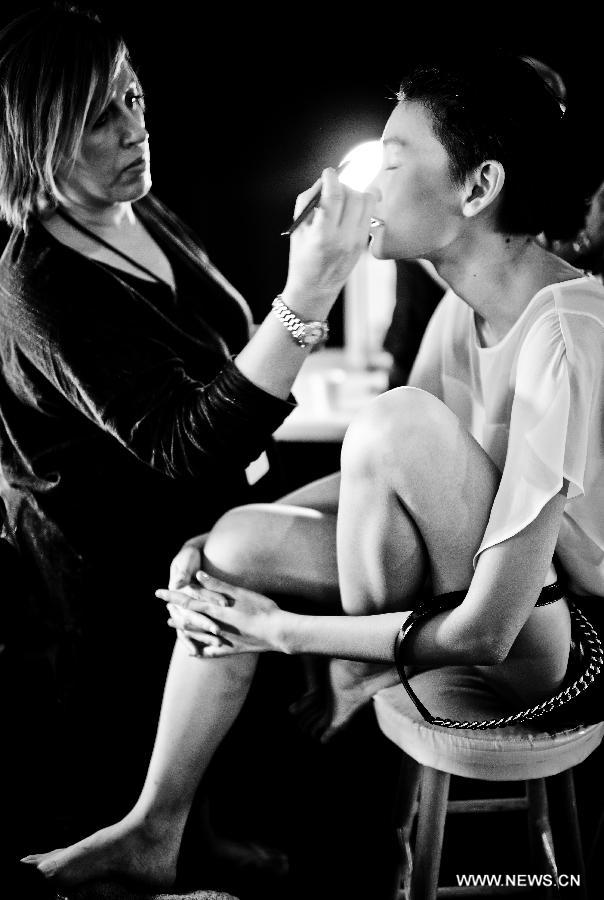 A model has her make-up done backstage during the Vivienne Tam Spring/Summer 2013 collection show at New York Fashion Week in New York, the United States, Sept. 12, 2012. (Xinhua/Shen Hong) 