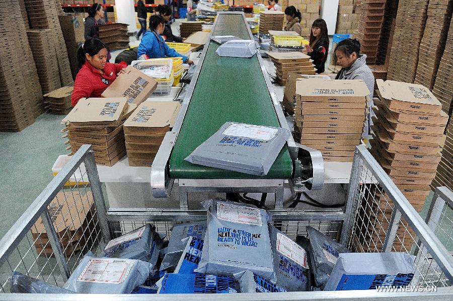 Photo taken on Nov. 11, 2012 shows staff members packing goods at the logistics center of Hangzhou 7gege Company, an online store at Taobao.com in Hangzhou, capital of east China's Zhejiang Province. (Xinhua/Huang Zongzhi) 