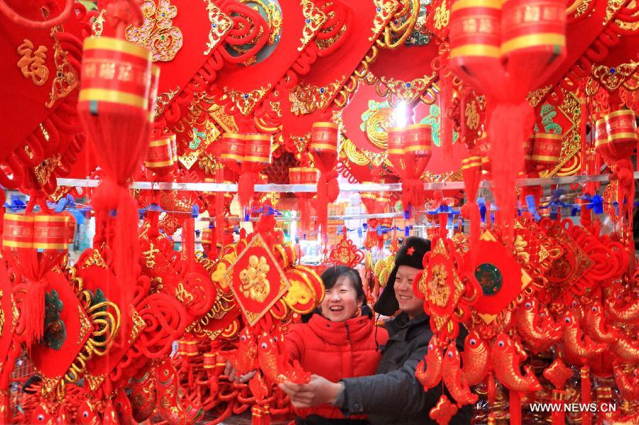 Customers select ornaments to greet the upcoming Spring Festival, which falls on Feb. 10 this year, in Jimo City, east China's Shandong Province, Jan. 8, 2013. (Xinhua/Liang Xiaopeng)