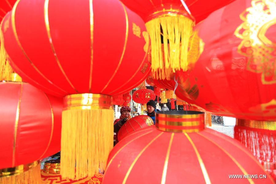 Customers select red lanterns to greet the upcoming Spring Festival, which falls on Feb. 10 this year, in Jimo City, east China's Shandong Province, Jan. 8, 2013. (Xinhua/Liang Xiaopeng)