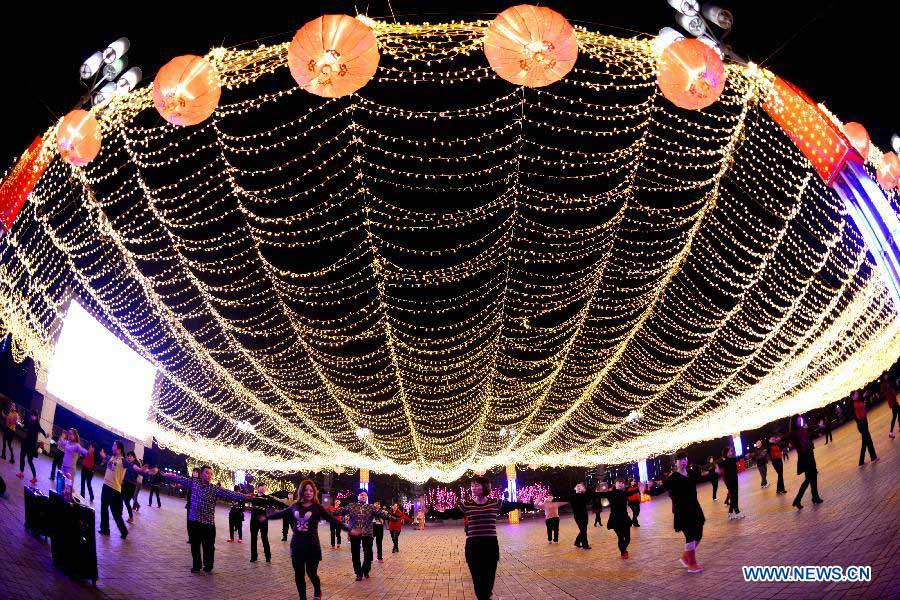 Citizens dance at the Chaotianmen Square in southwest China's Chongqing, Jan. 7, 2013. Many roads and squares in the city were decorated with lights to greet the Spring Festival which falls on Feb. 10 this year. (Xinhua/Zhong Guilin)