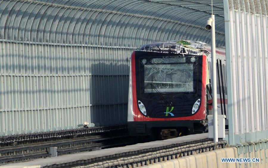 A broken metro train is seen on the rail in Kunming, capital of southwest China's Yunnan Province, Jan. 8, 2013. One driver was killed and another injured during a test run of a metro line Tuesday in Kunming. A spokesman with the municipal government said that part of the test train on the metro line derailed, causing the vehicle's heating device to fall and hit the drivers in the driver cabin. (Xinhua)