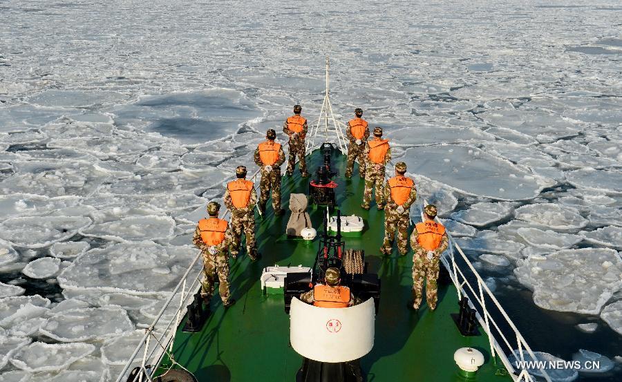Local coastal police officers are on duty on the sea covered by drift ice, in Qinhuangdao, north China's Hebei Province, Jan. 8, 2013. A cold snap has created a layer of thick sea ice in the offshore areas of the Bohai Bay in Hebei Province. (Xinhua/Yang Shiyao)