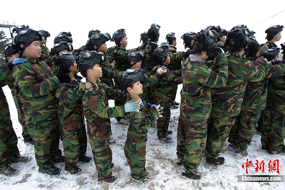 South Korean primary and secondary school students have military training in snow without shirts in a boot camp in Daebu, Ansan, South Korea, Dec. 27, 2010. (Photo/Chinanews.com)