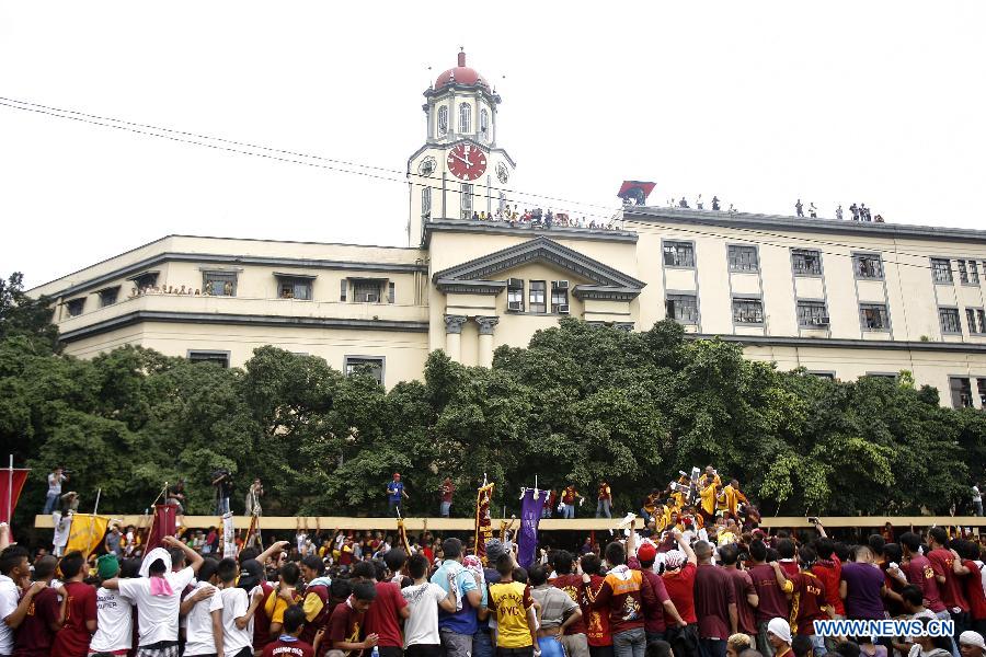 Devotees try to touch and kiss the life-size statue of the Black Nazarene during the annual feast of the Black Nazarene in Manila, the Philippines, Jan. 9, 2013. The Black Nazarene, a life-size wooden statue of Jesus Christ carved in Mexico and brought to the Philippines in the 17th century, is believed to have healing powers in this country. Authorities said about 500,000 people participated in the procession that started in Manila's Rizal Park. (Xinhua/Rouelle Umali)