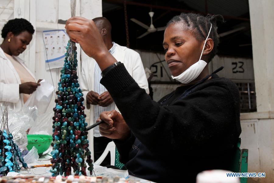 A woman paints on ceramic beads at the Kazuri factory in Nairobi, Kenya, Jan. 8, 2013. Kazuri, which means "small and beautiful" in Swahili, began in 1975 as a workshop experimenting on making handmade beads. The factory employs over 340 women, mostly single mothers. Its handmade and hand-painted ceramic jewellery and pottery products have been exported to over 30 countries and regions worldwide. (Xinhua/Meng Chenguang)
